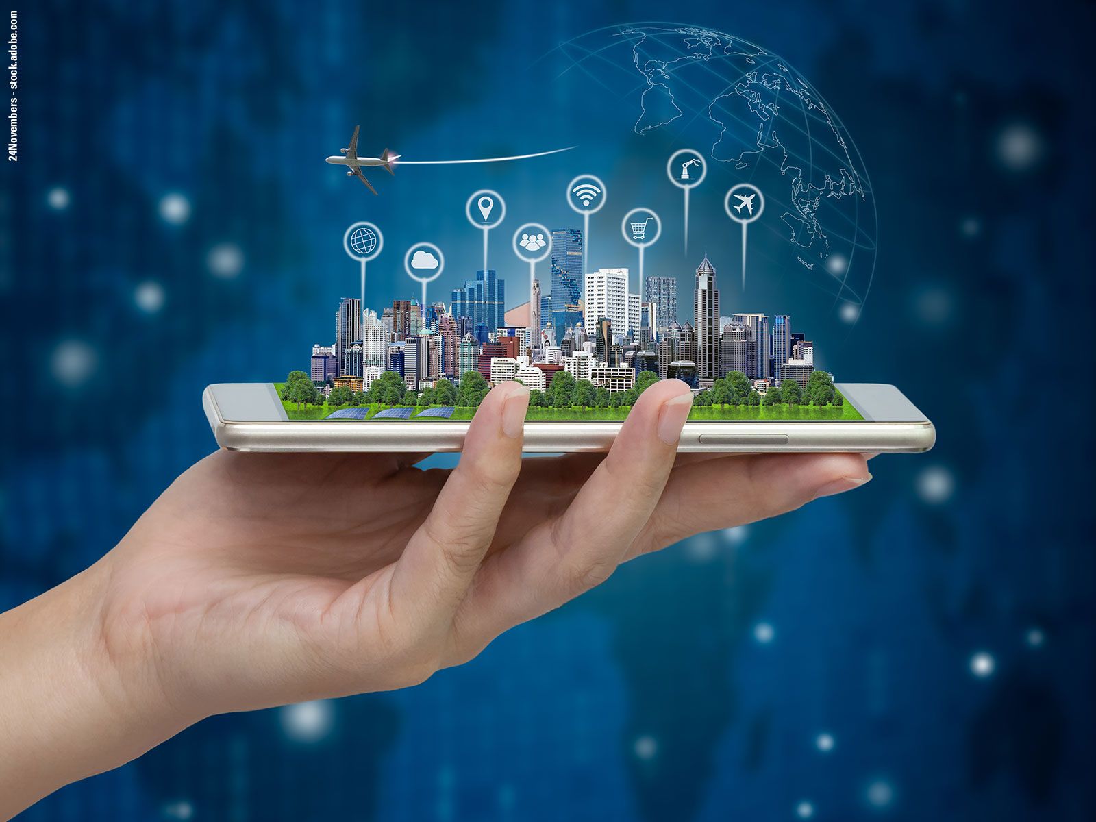 A person holding a smartphone displaying a city skyline, with an airplane, various digital icons, and a globe floating above it.